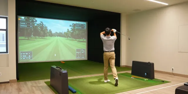 How to build home golf sim with a golfer practicing swing in a well-designed indoor simulator.